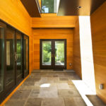 Warm wood-lined entryway in luxury custom home