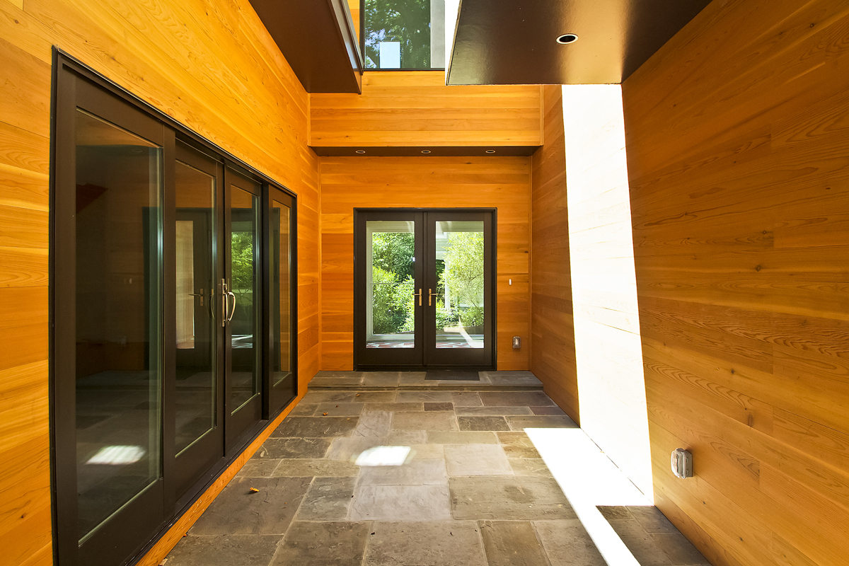 Warm wood-lined entryway in luxury custom home