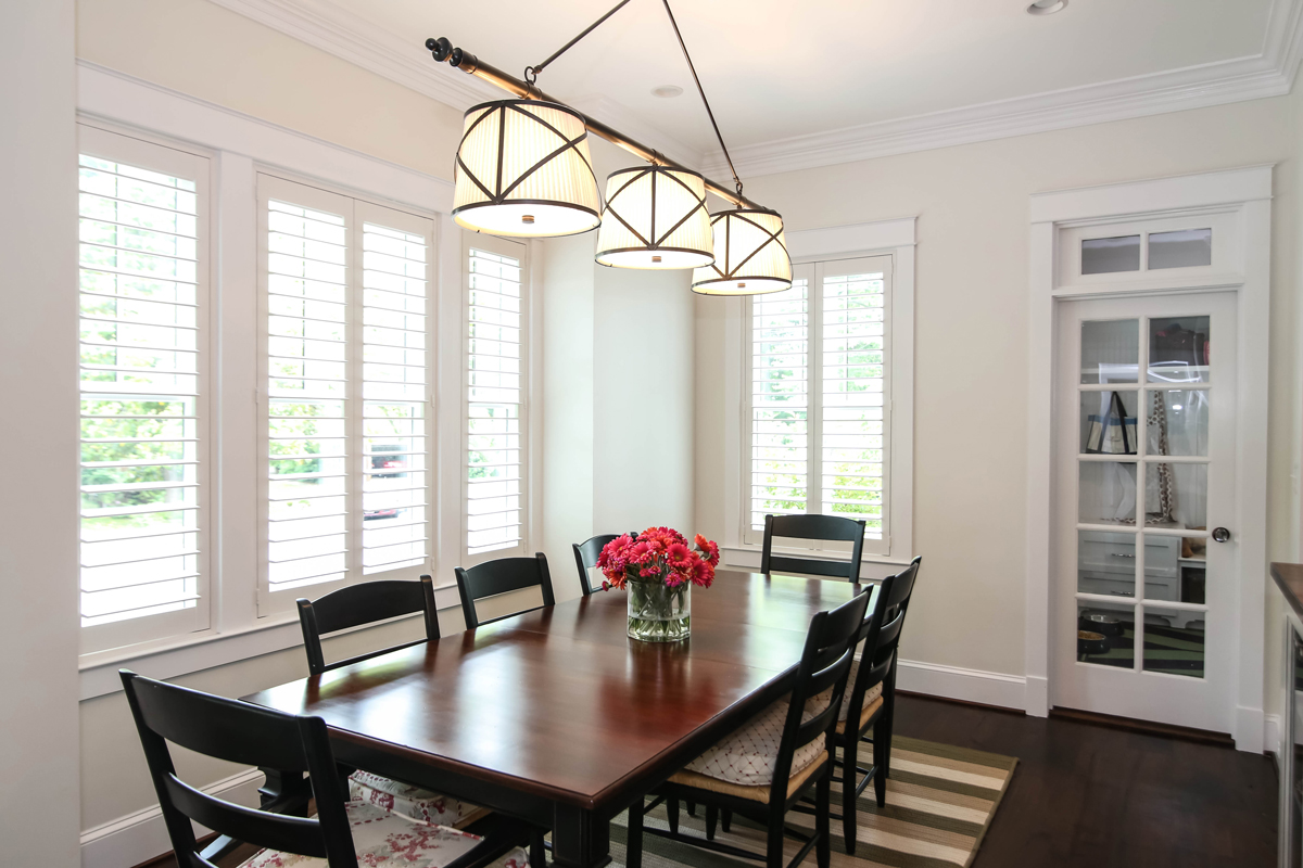 Sleek and bright dining room with dark wood table and chairs