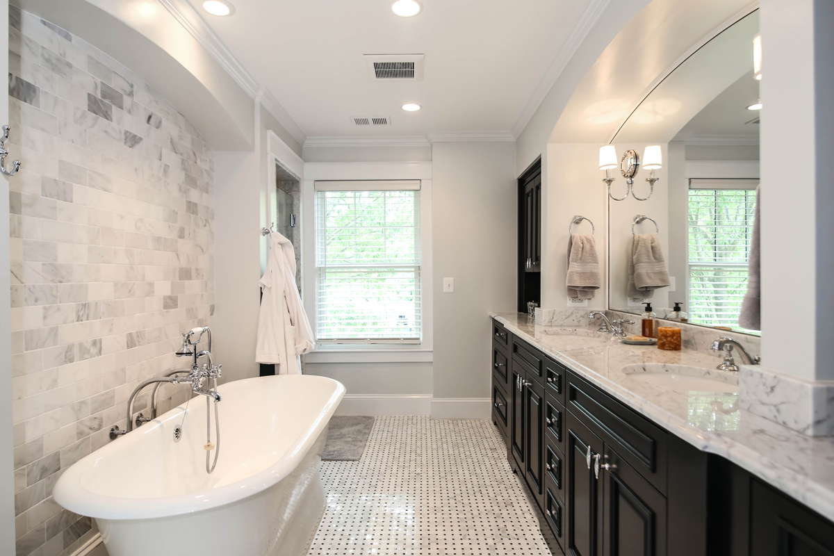 Glossy, modern bathroom with a claw-foot tub