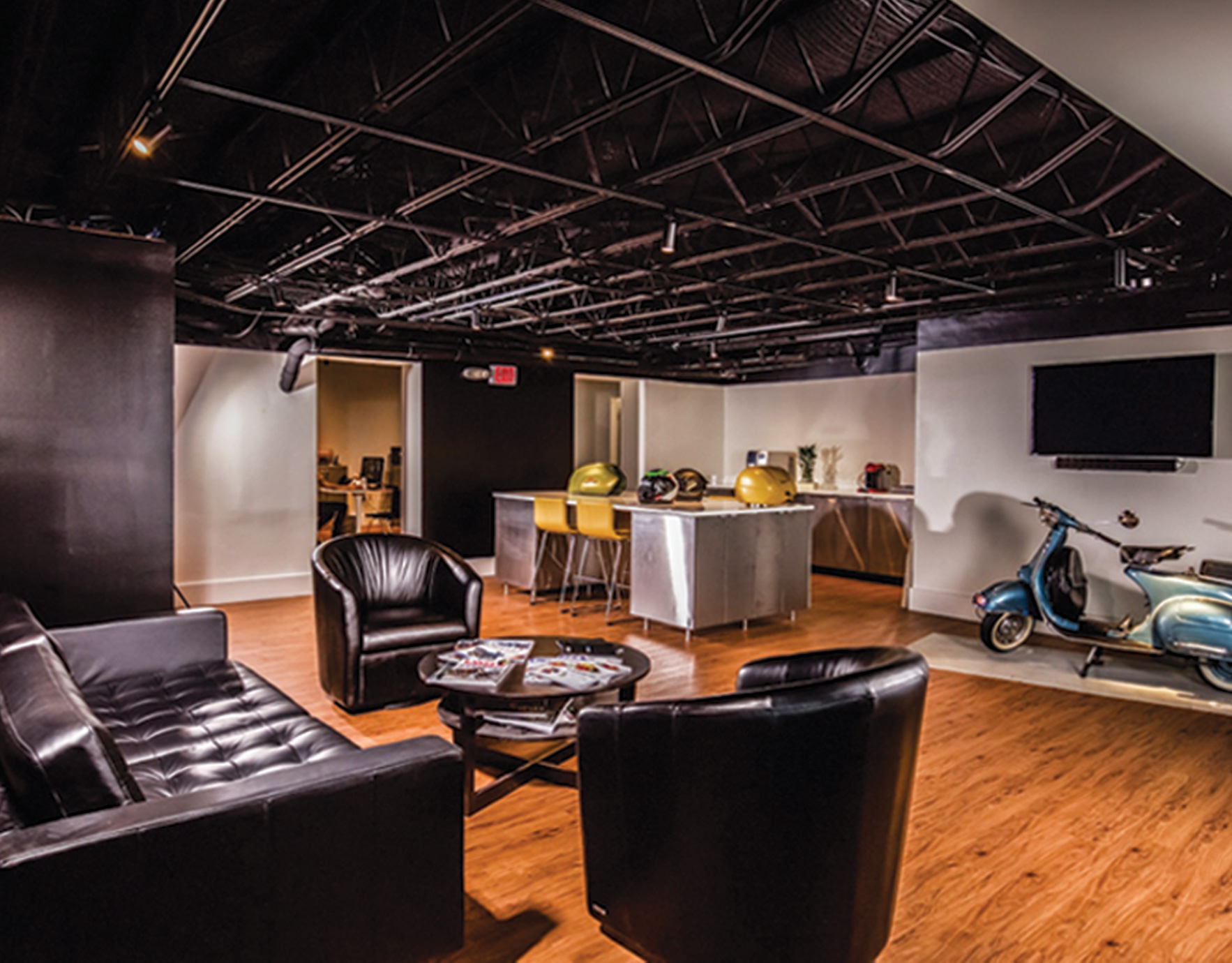 Open concept commercial working space with vespa in the corner