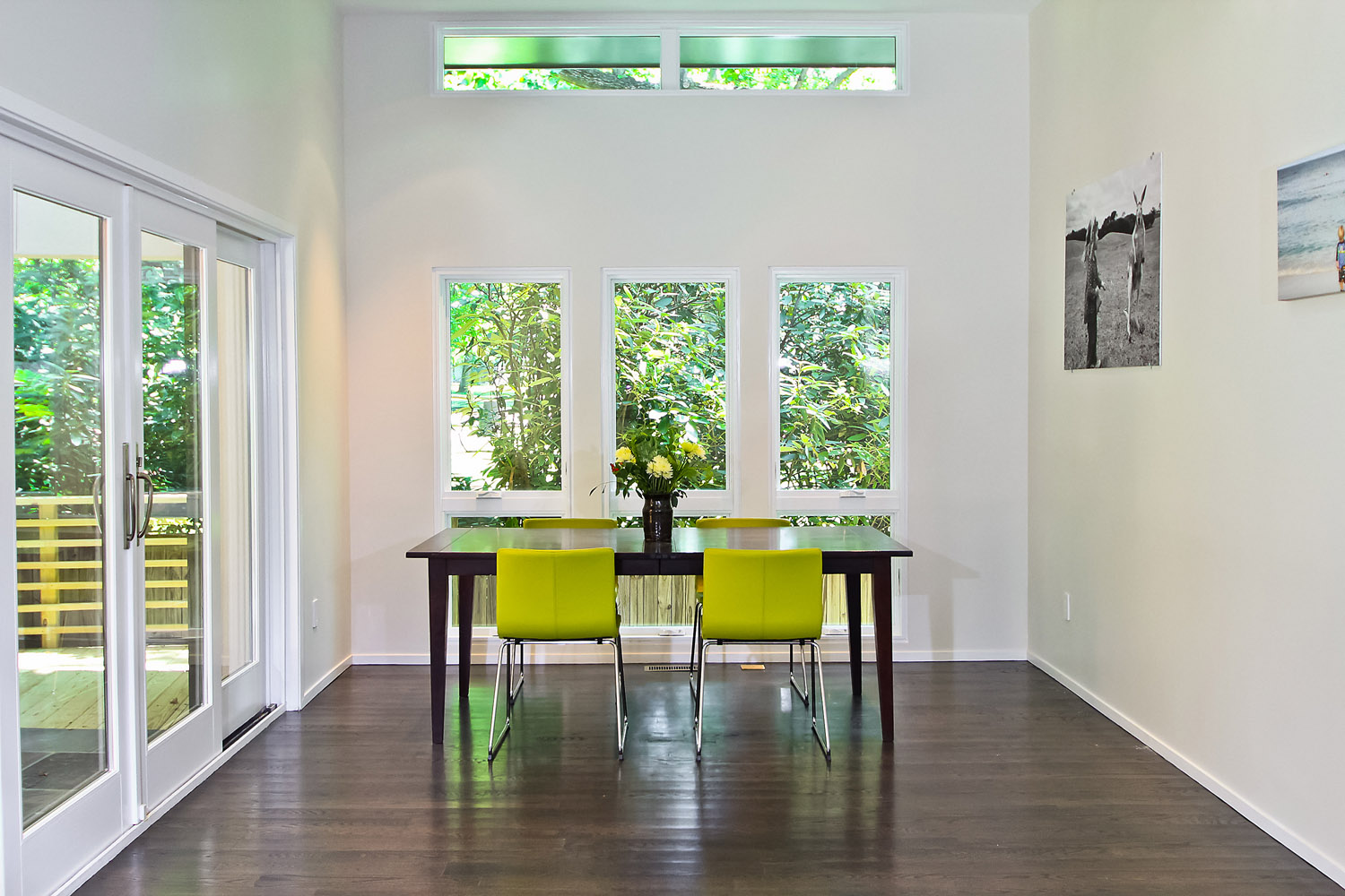 Open, airy dining room with white walls and lime green modern chairs