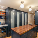 Blue Kitchen with Dark Wood Island Counter and Tall Cabinets