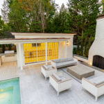 Luxurious Outdoor Space with Seating Area, Fireplace, Outdoor Kitchen, and Pool