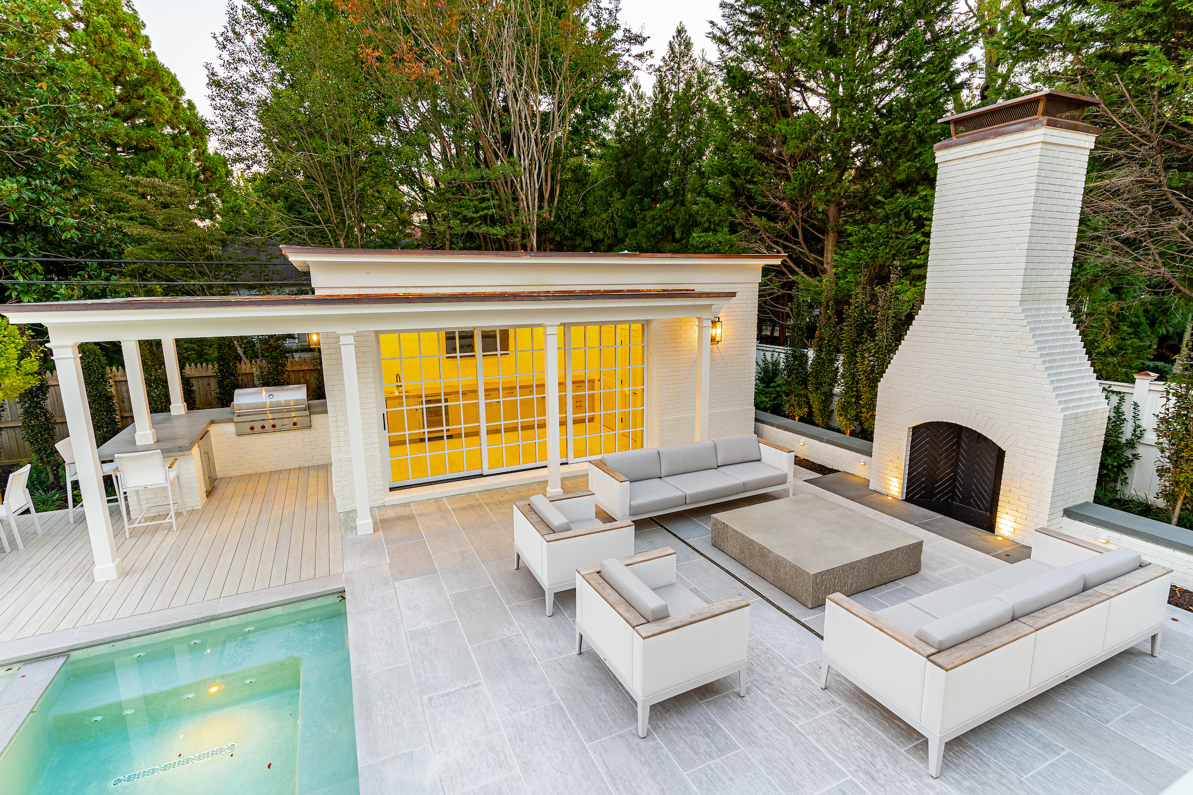 Luxurious Outdoor Space with Seating Area, Fireplace, Outdoor Kitchen, and Pool