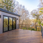 Patio with Dark Wood Surrounded By Lush Mature Trees