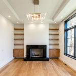 Black fireplace and modern chandelier in DC Home