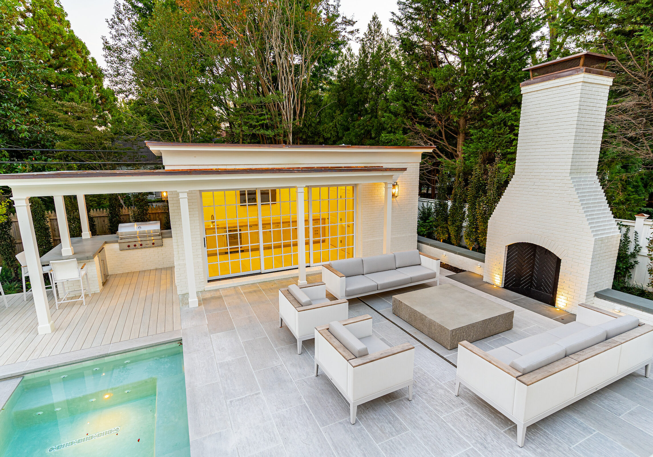 Luxurious Outdoor Space with Seating Area, Fireplace, Outdoor Kitchen, and Pool